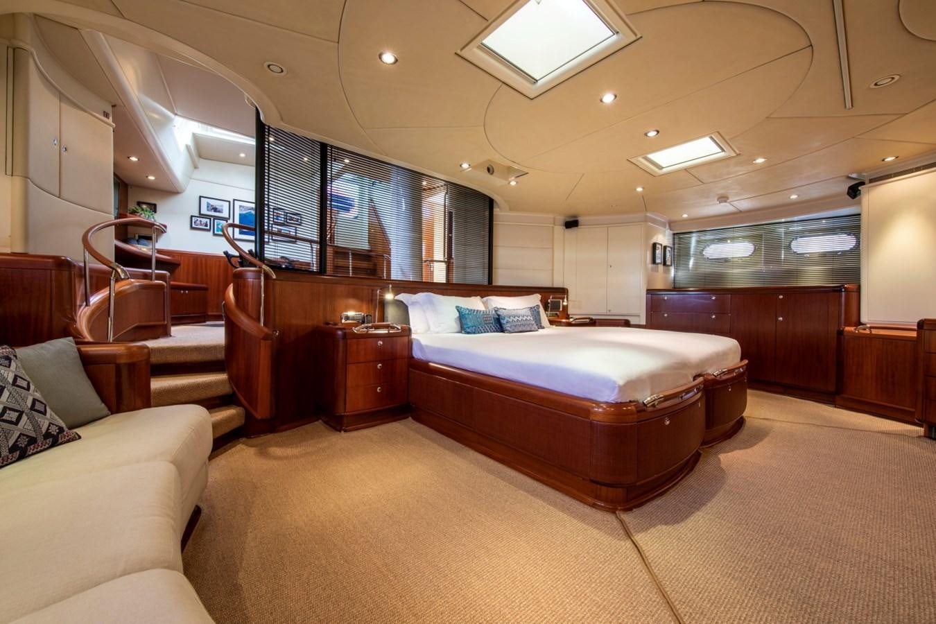 a bedroom with a bed and a couch aboard SURAMA Yacht for Sale