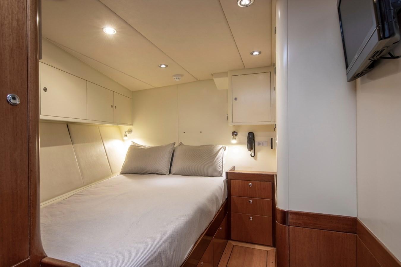 a room with a bed and a television aboard SURAMA Yacht for Sale