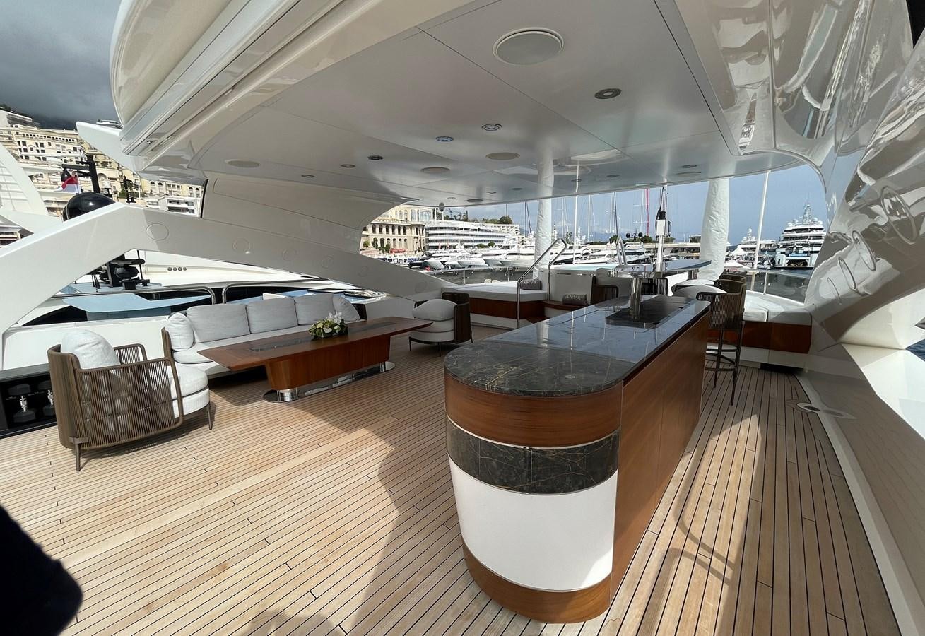 a room with a wood floor and a large window with a view of the city below aboard ANYA Yacht for Charter