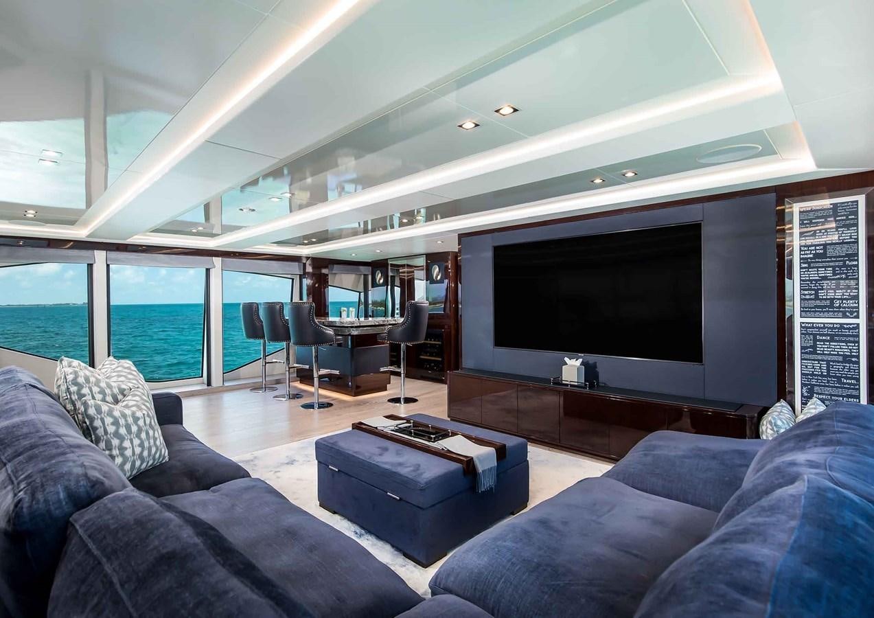 a living room with a large screen aboard CAPTAIN MORGAN III Yacht for Sale