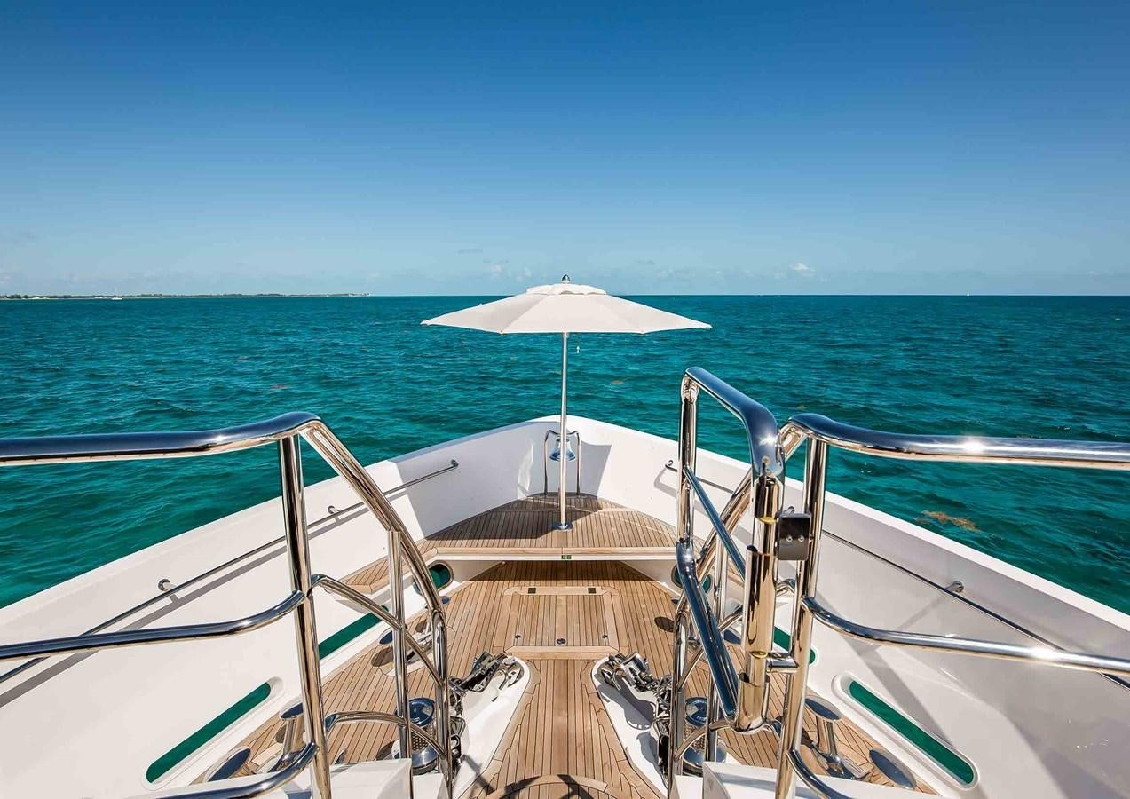 a boat with an umbrella on the water aboard CAPTAIN MORGAN III Yacht for Sale