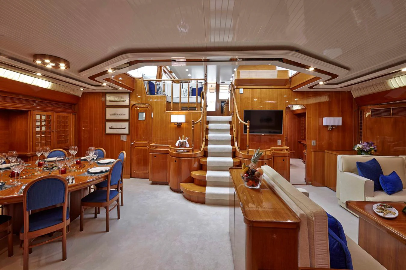 a large room with wooden stairs aboard MIRABELLA Yacht for Sale