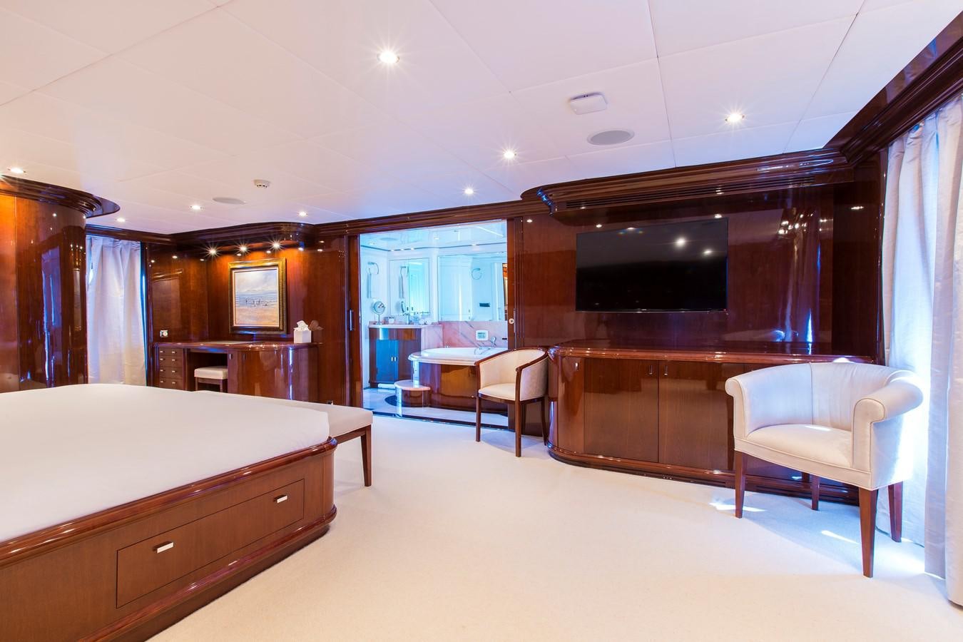 a large room with a bed and chairs aboard SILENTWORLD Yacht for Sale
