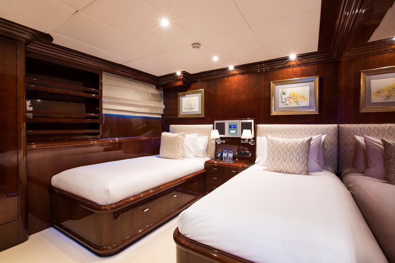 a room with a bed and a desk aboard SILENTWORLD Yacht for Sale