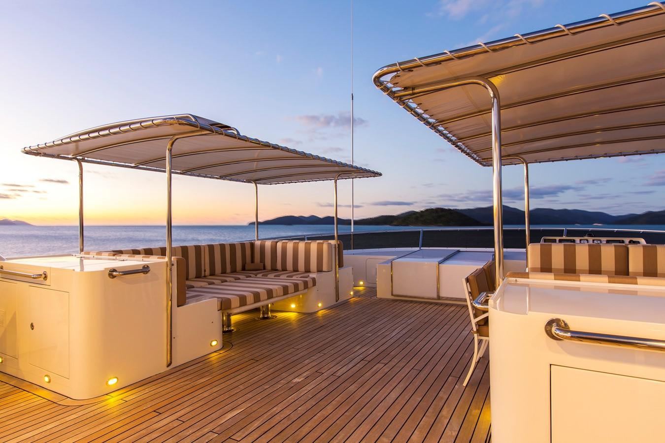 a deck with a covered patio and a large body of water aboard SILENTWORLD Yacht for Sale