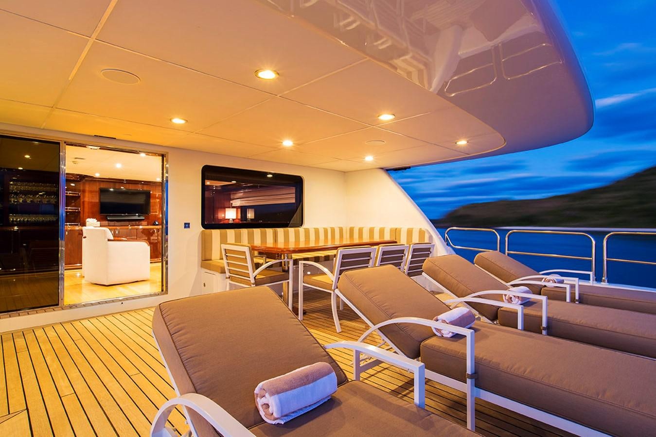 a room with a pool and a table and chairs aboard SILENTWORLD Yacht for Sale