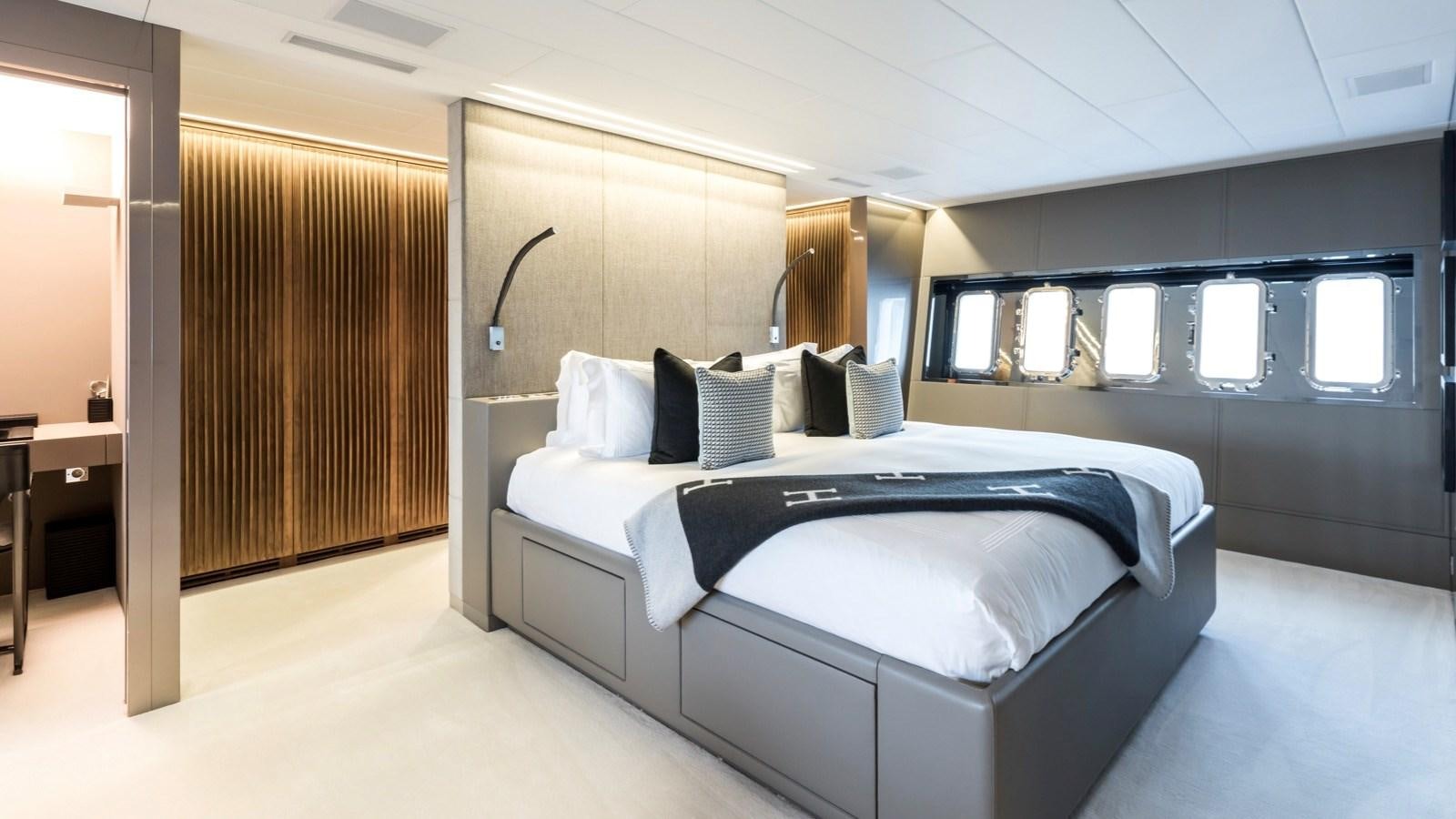 a room with a bed and a window aboard BEACHOUSE Yacht for Charter