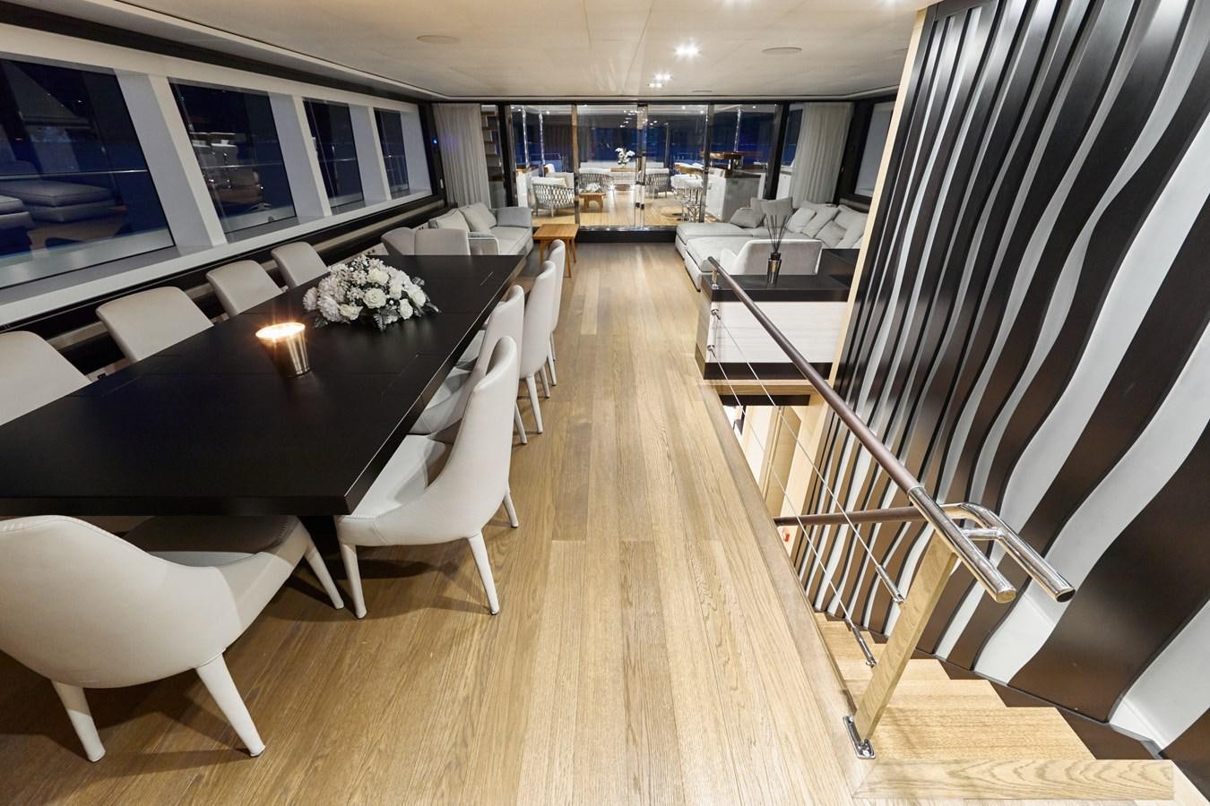 a room with a table chairs and a staircase aboard NORTH STAR Yacht for Sale