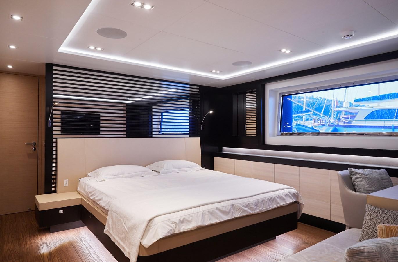 a room with a bed and a television aboard NORTH STAR Yacht for Sale