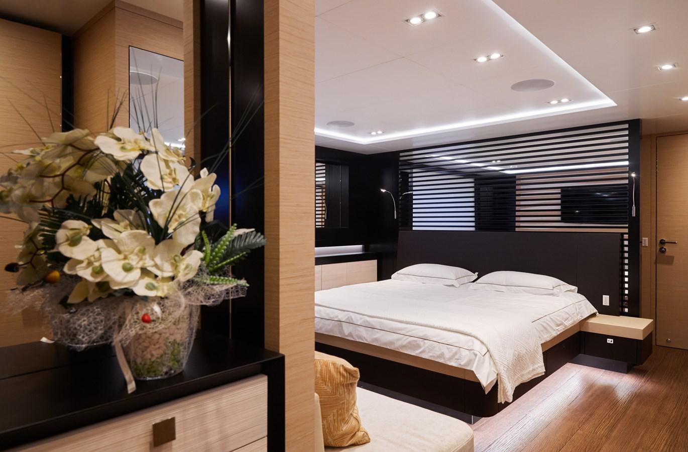 a room with a bed and a plant in it aboard NORTH STAR Yacht for Sale