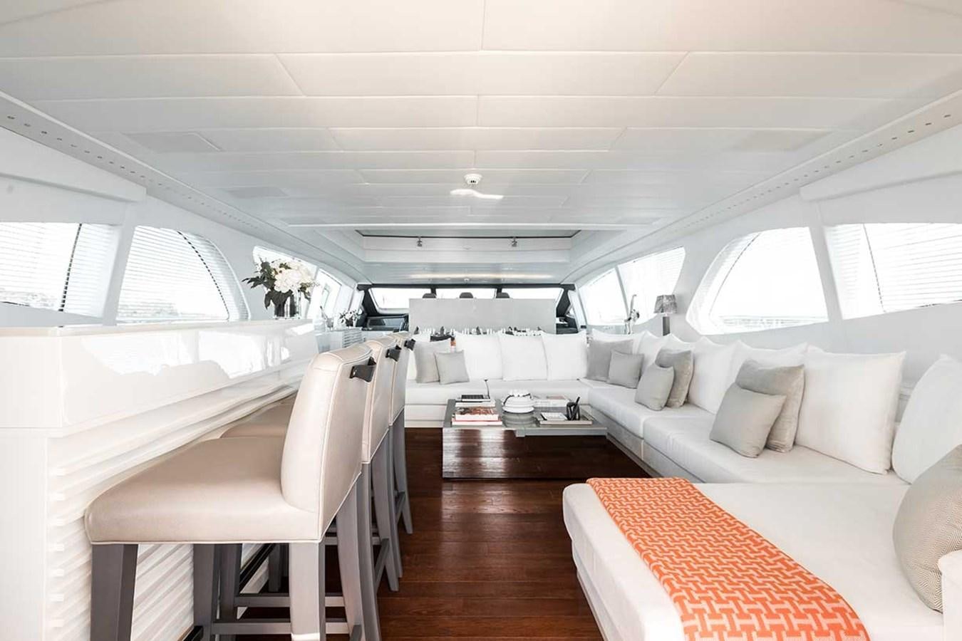 a room with a bed and a chair aboard BEACHOUSE Yacht for Sale