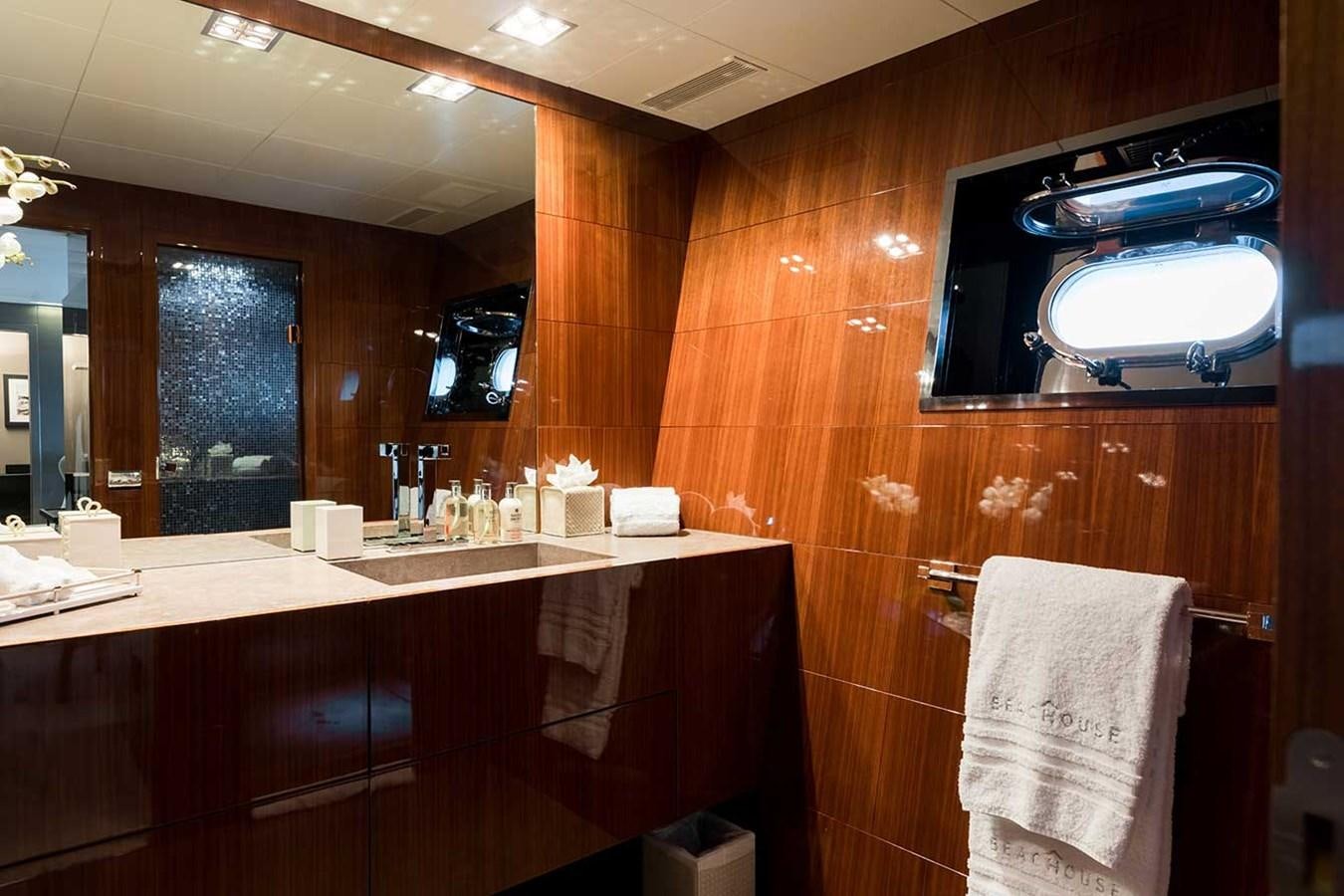 a bathroom with a countertop sink and cabinets aboard BEACHOUSE Yacht for Sale