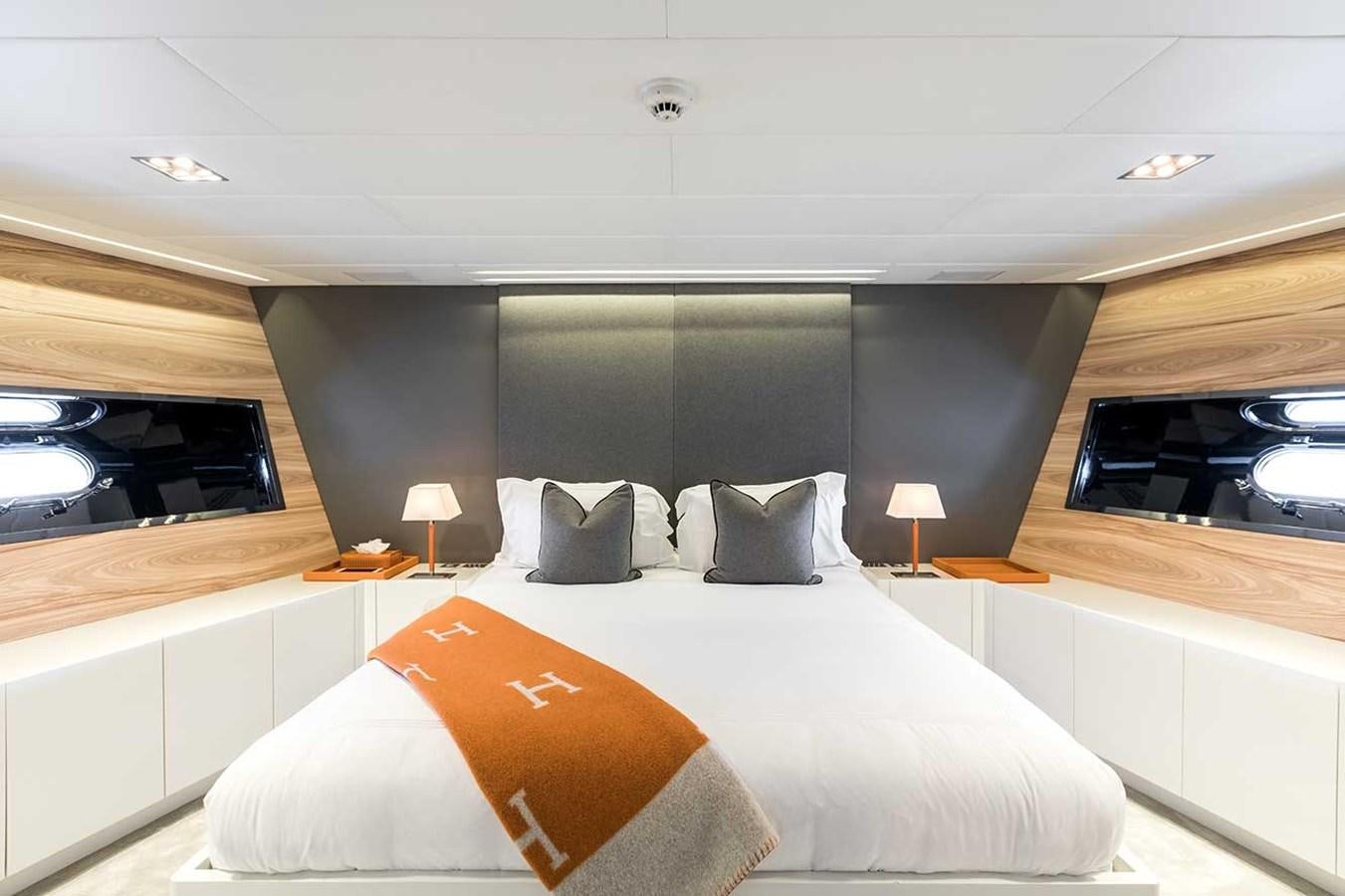 a room with a bed and a television aboard BEACHOUSE Yacht for Sale
