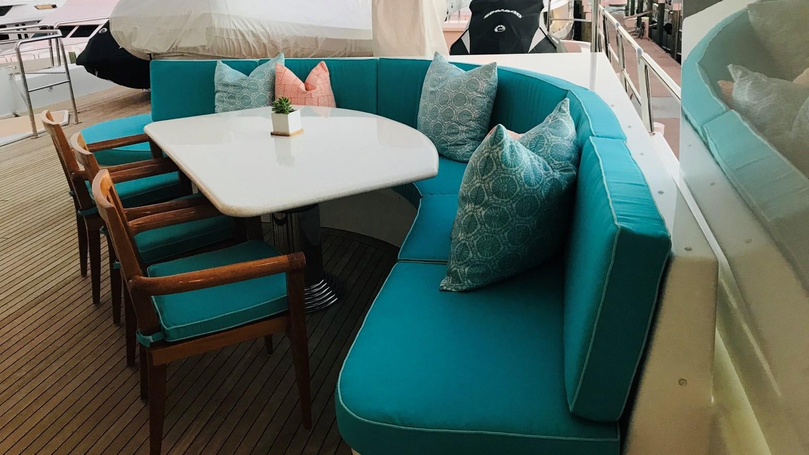 a table with chairs around it aboard RELENTLESS Yacht for Sale