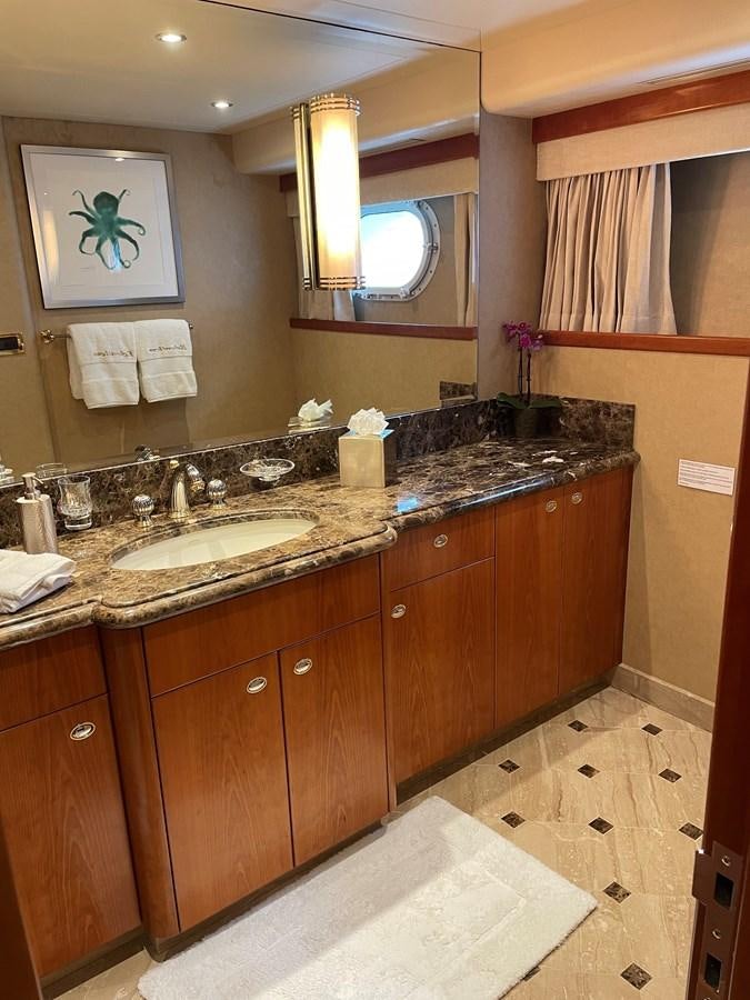 a bathroom with a sink and a mirror aboard RELENTLESS Yacht for Sale