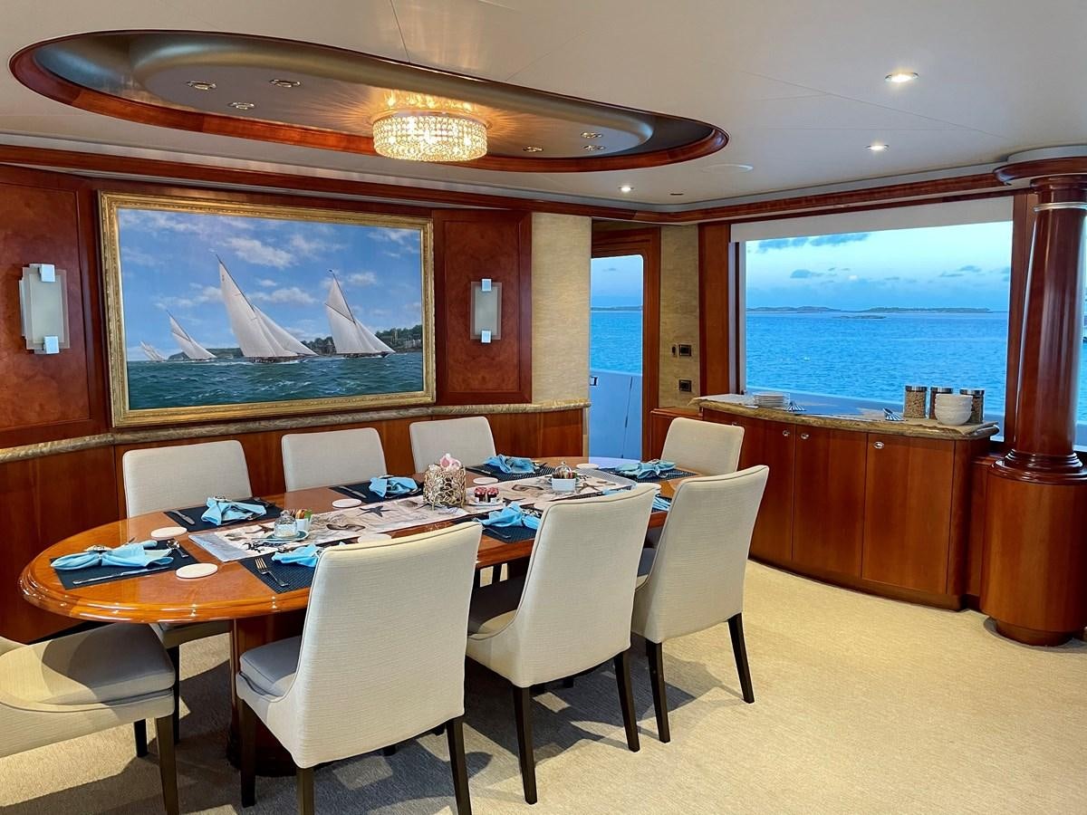 a large room with a table and chairs aboard RELENTLESS Yacht for Sale