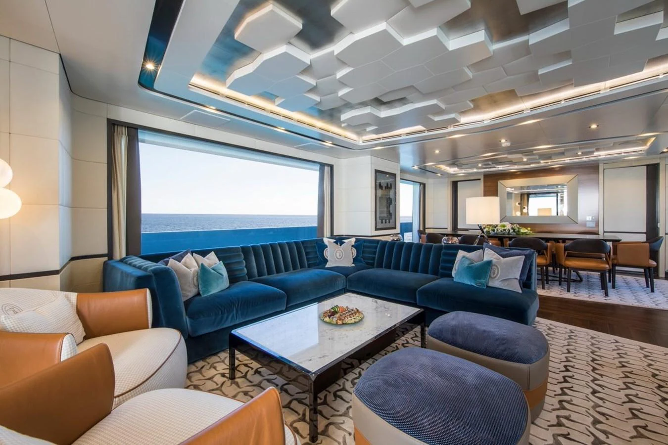 a room with a blue couch and a table with a blue couch aboard SPRING Yacht for Sale