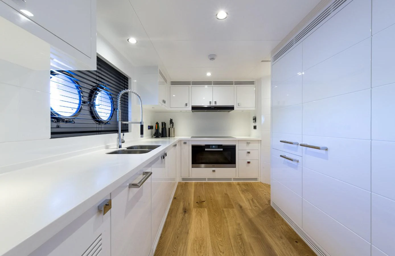 a kitchen with white cabinets aboard S7 Yacht for Sale