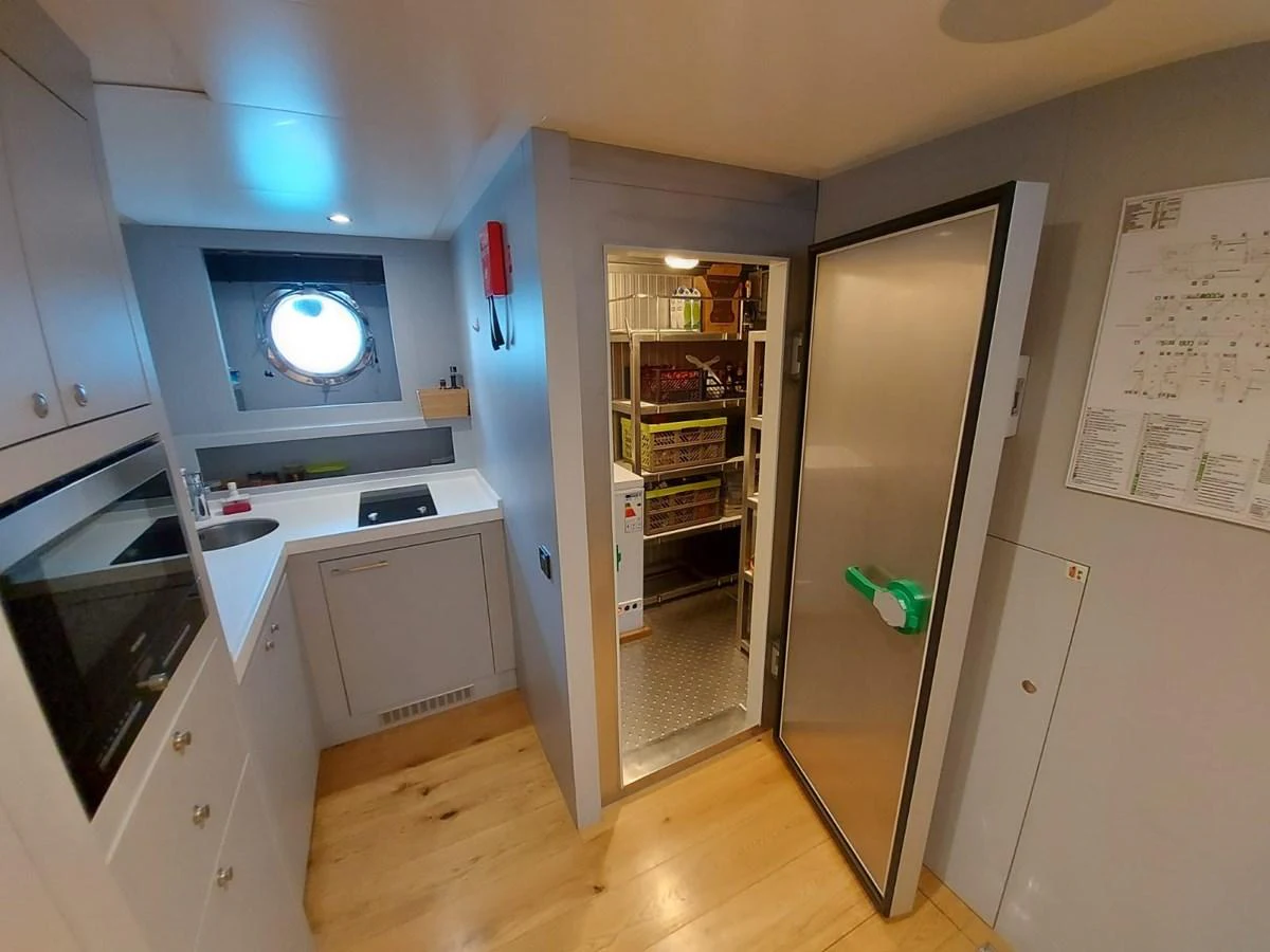 a room with a tv and cabinets aboard S7 Yacht for Sale