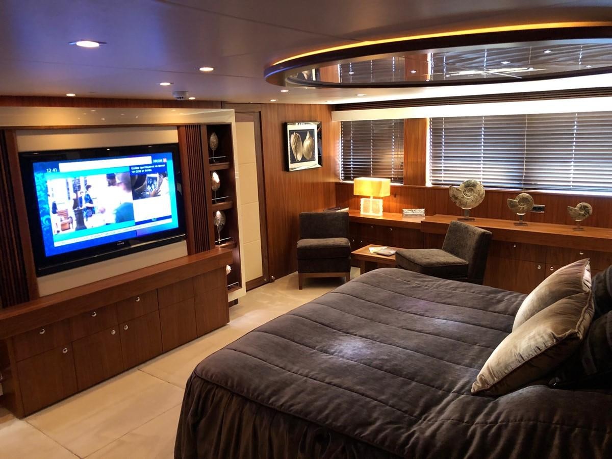 a hotel room with a tv and a bed aboard REGULUS Yacht for Sale
