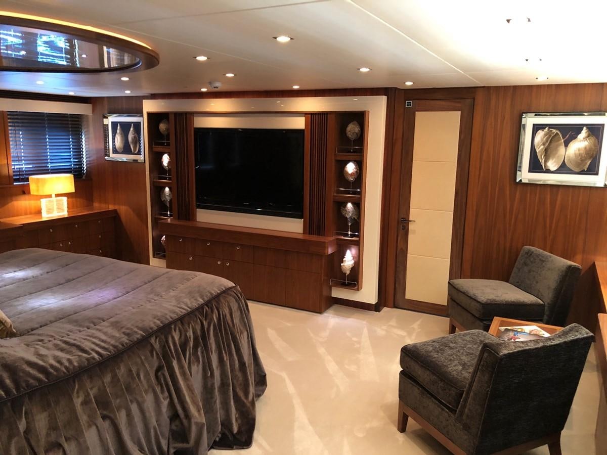 a hotel room with a bed and a television aboard REGULUS Yacht for Sale