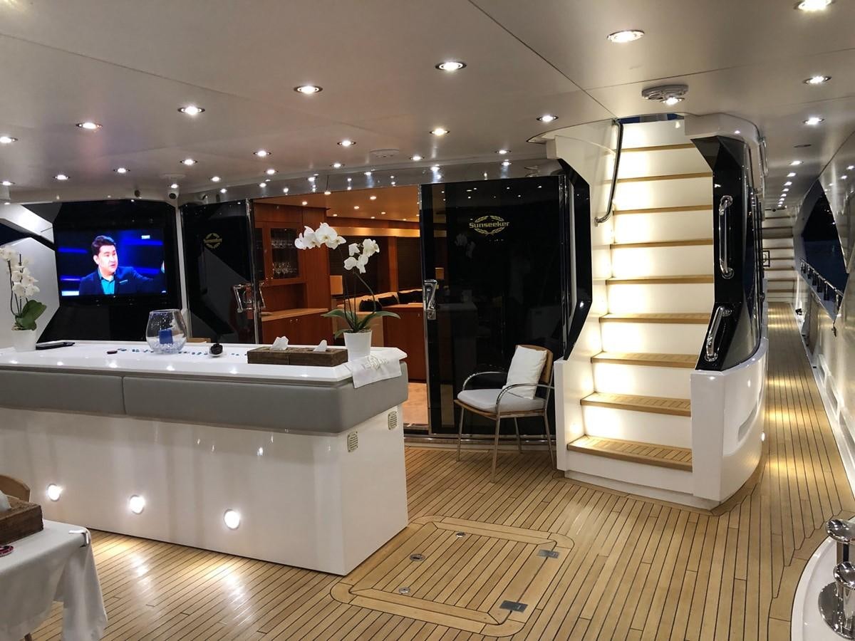 a room with a tv and a table aboard REGULUS Yacht for Sale