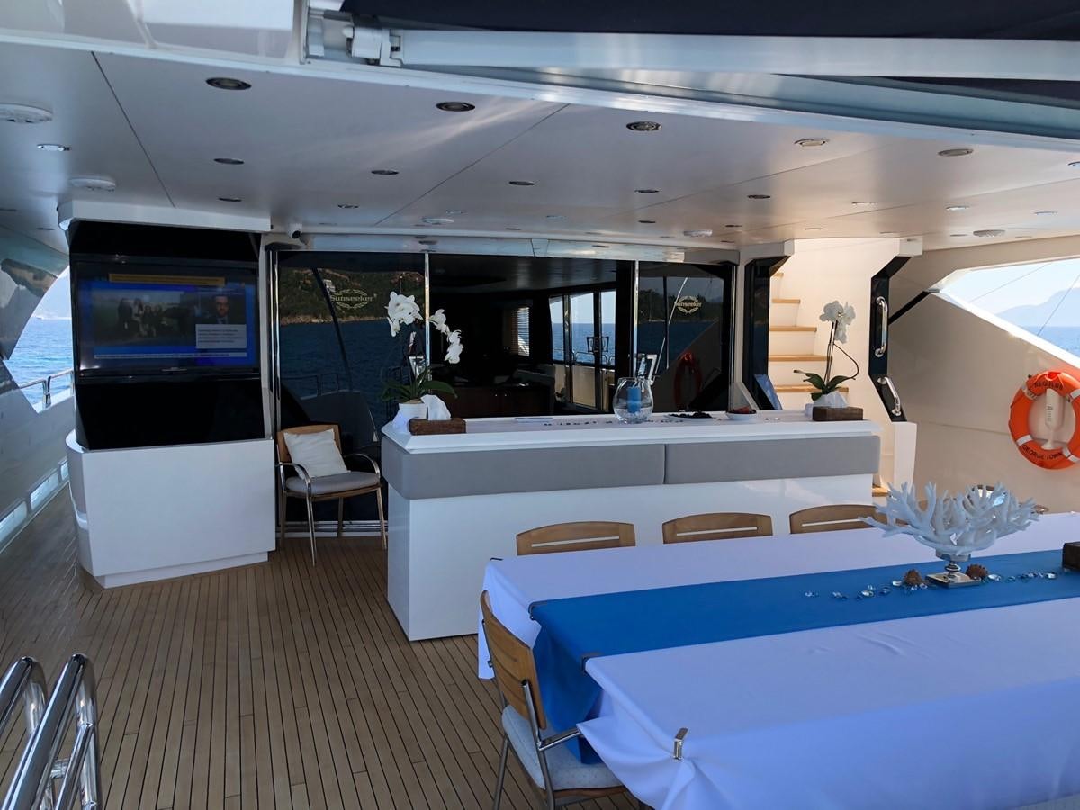 a kitchen with a table and chairs aboard REGULUS Yacht for Sale