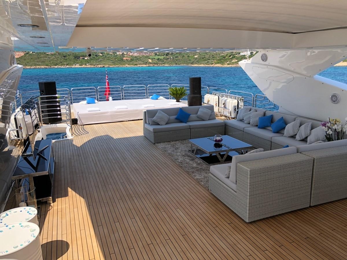 a deck with a couch and a pool aboard REGULUS Yacht for Sale
