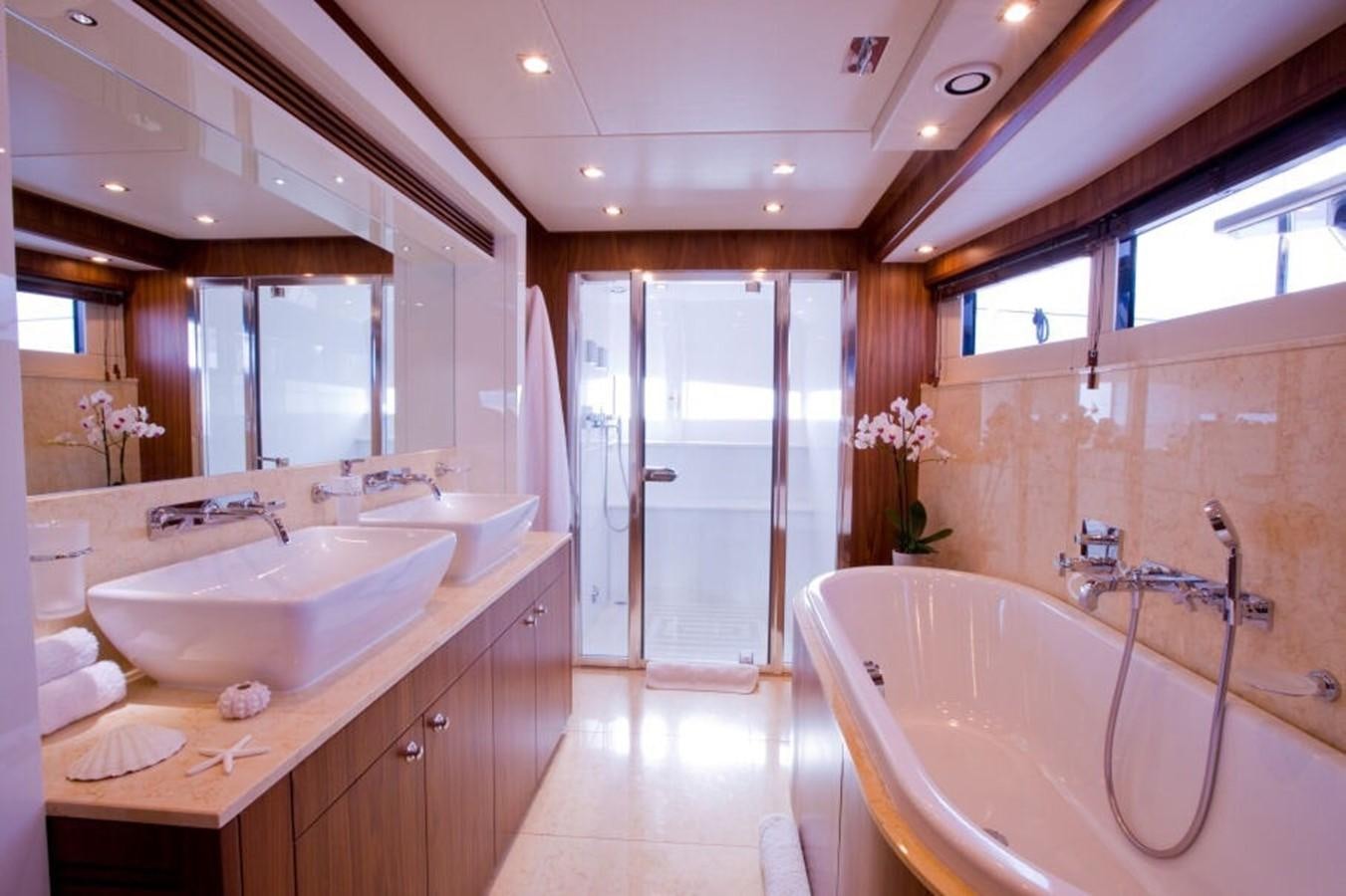 a bathroom with a tub sink and a shower unit aboard REGULUS Yacht for Sale