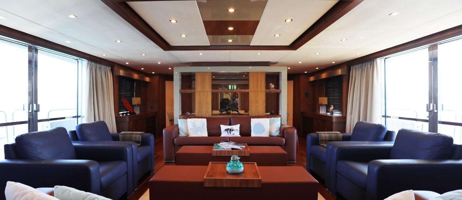 a living room with a couch and a table aboard J & LI Yacht for Sale