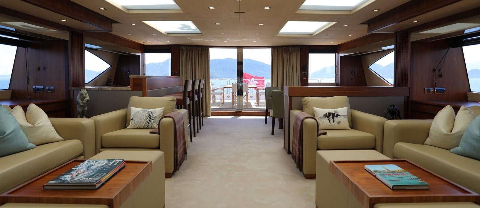 a living room with a couch and a table aboard J & LI Yacht for Sale