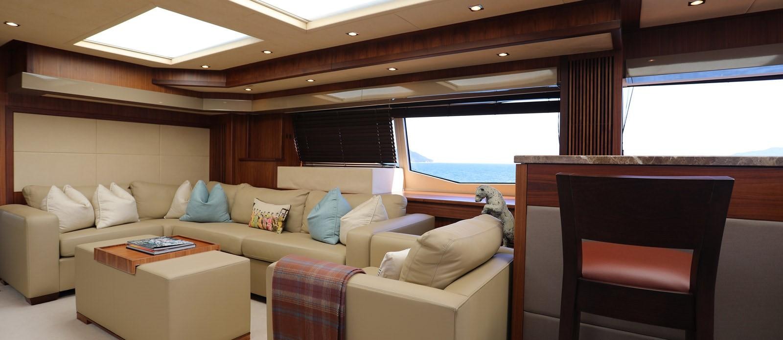 a living room with a couch and a tv aboard J & LI Yacht for Sale