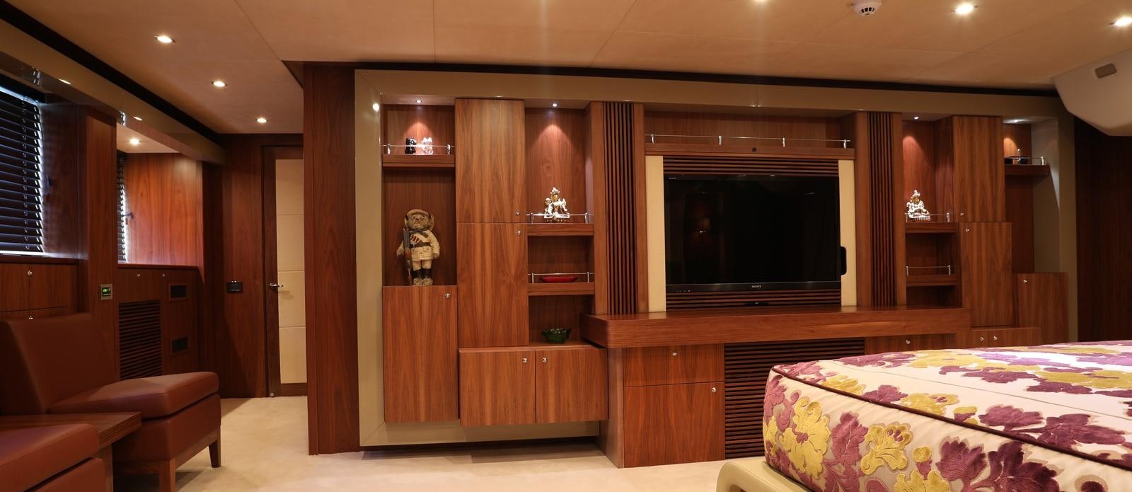 a room with a bed and a television aboard J & LI Yacht for Sale