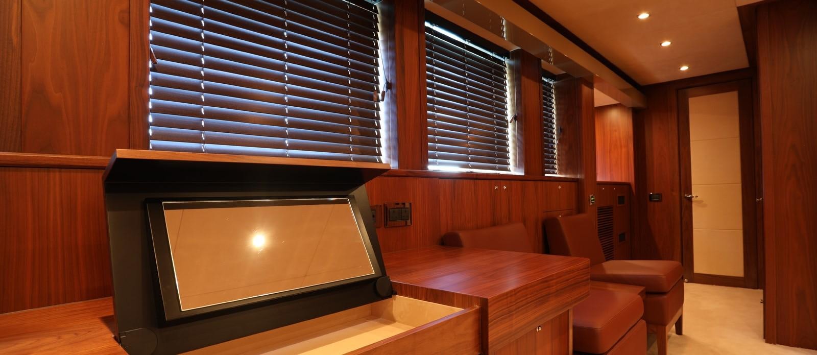 a room with a tv and a table aboard J & LI Yacht for Sale