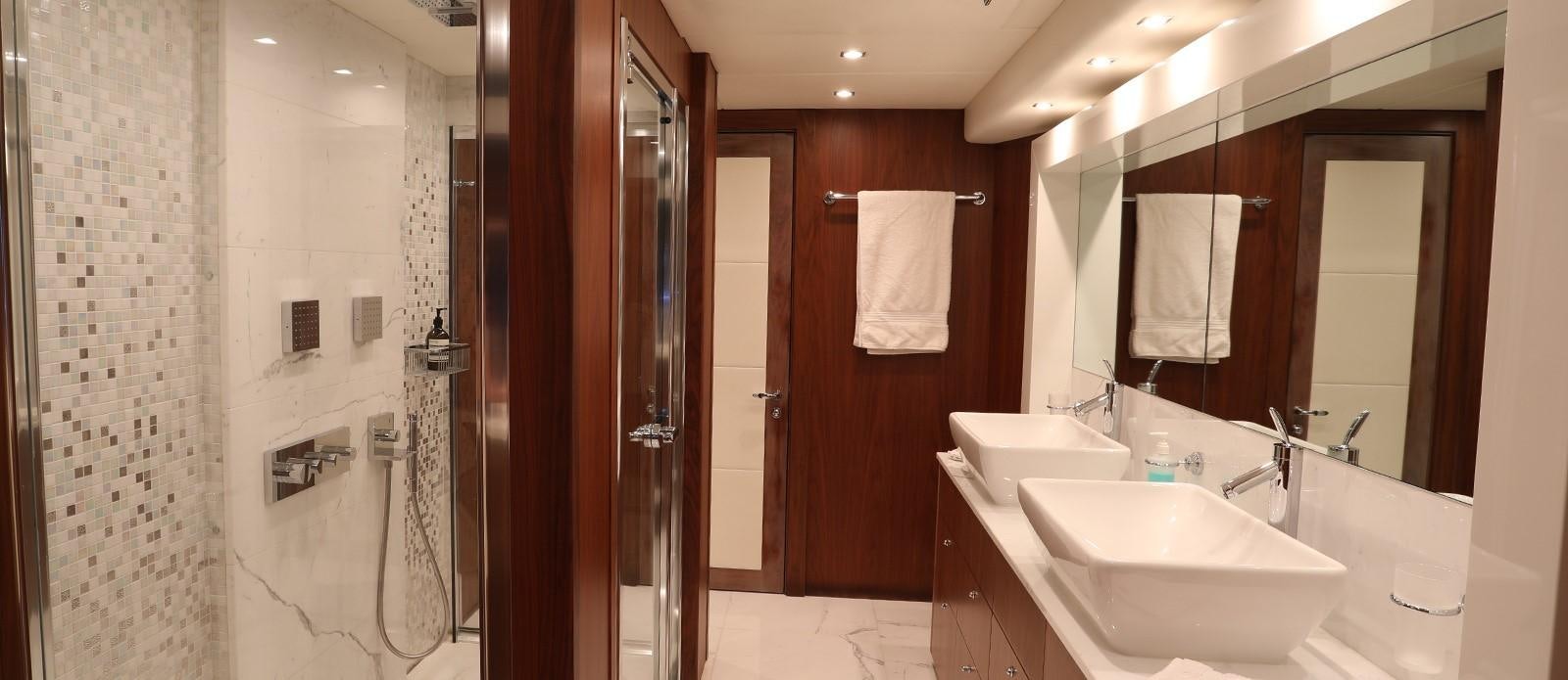 a bathroom with a sink and a mirror aboard J & LI Yacht for Sale