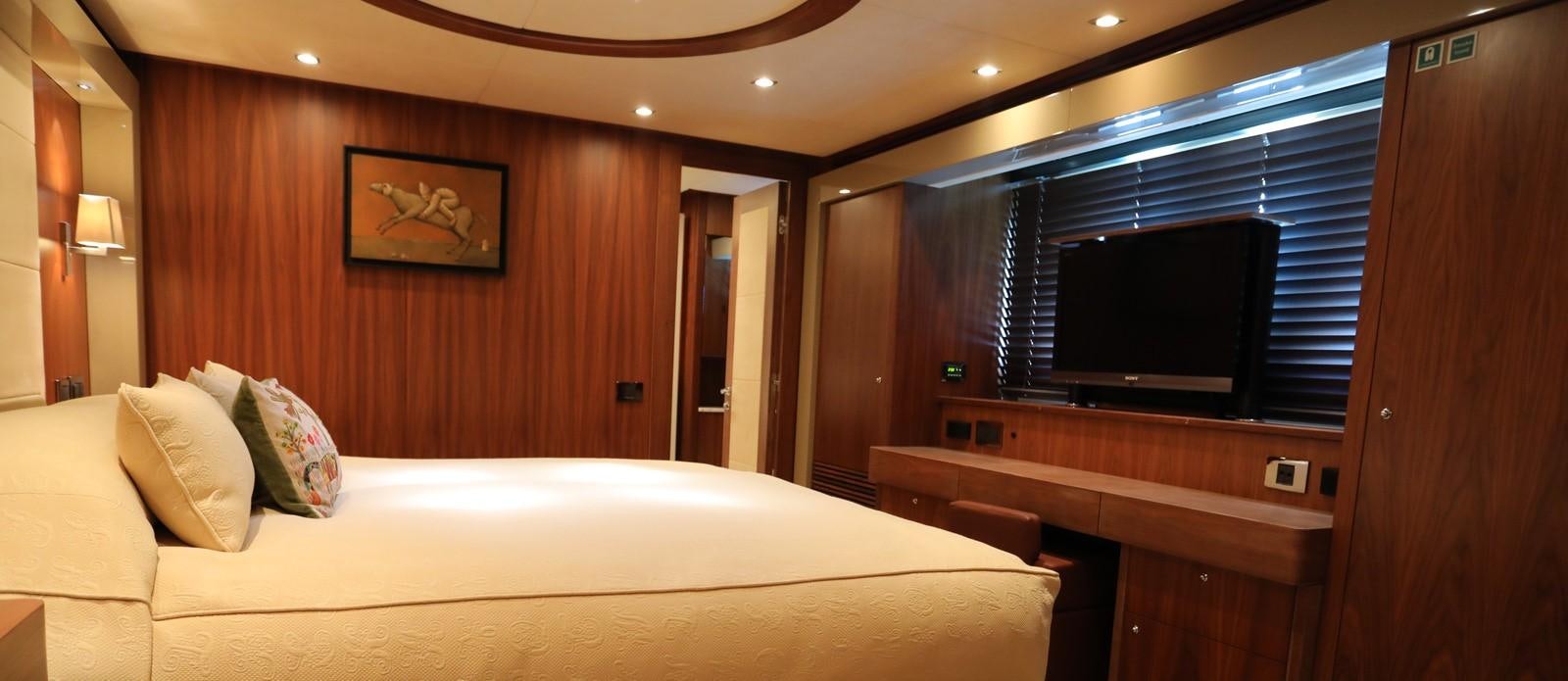a hotel room with a bed and tv aboard J & LI Yacht for Sale