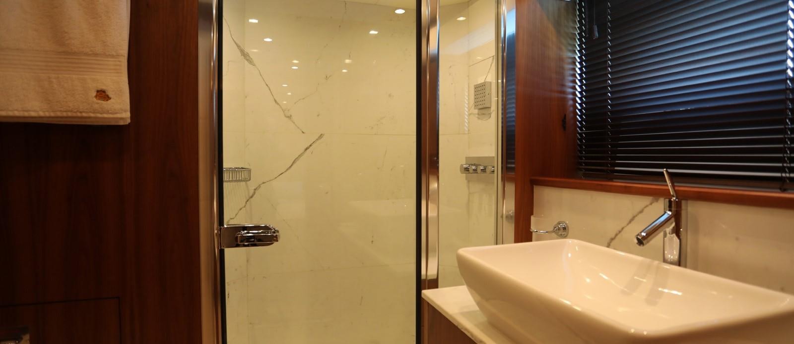 a bathroom with a sink and a mirror aboard J & LI Yacht for Sale