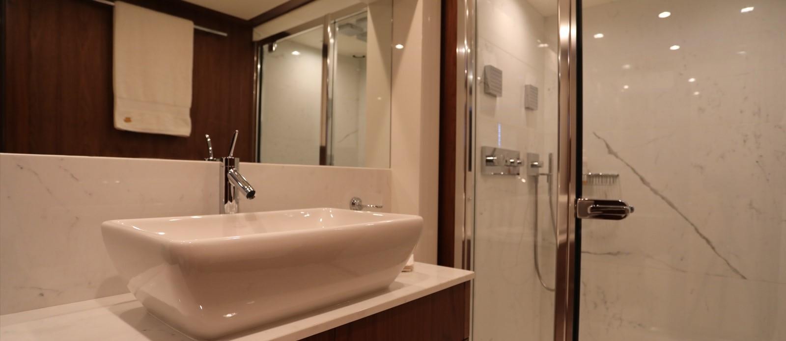 a bathroom sink and mirror aboard J & LI Yacht for Sale