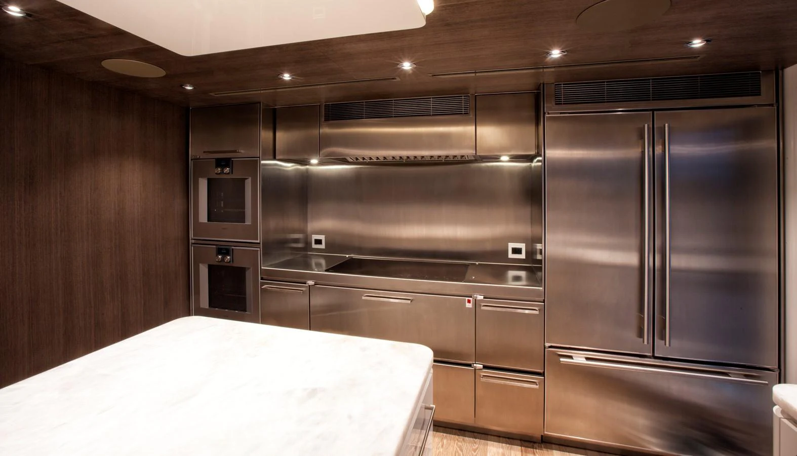 a kitchen with stainless steel appliances aboard PEPPER XIII Yacht for Sale