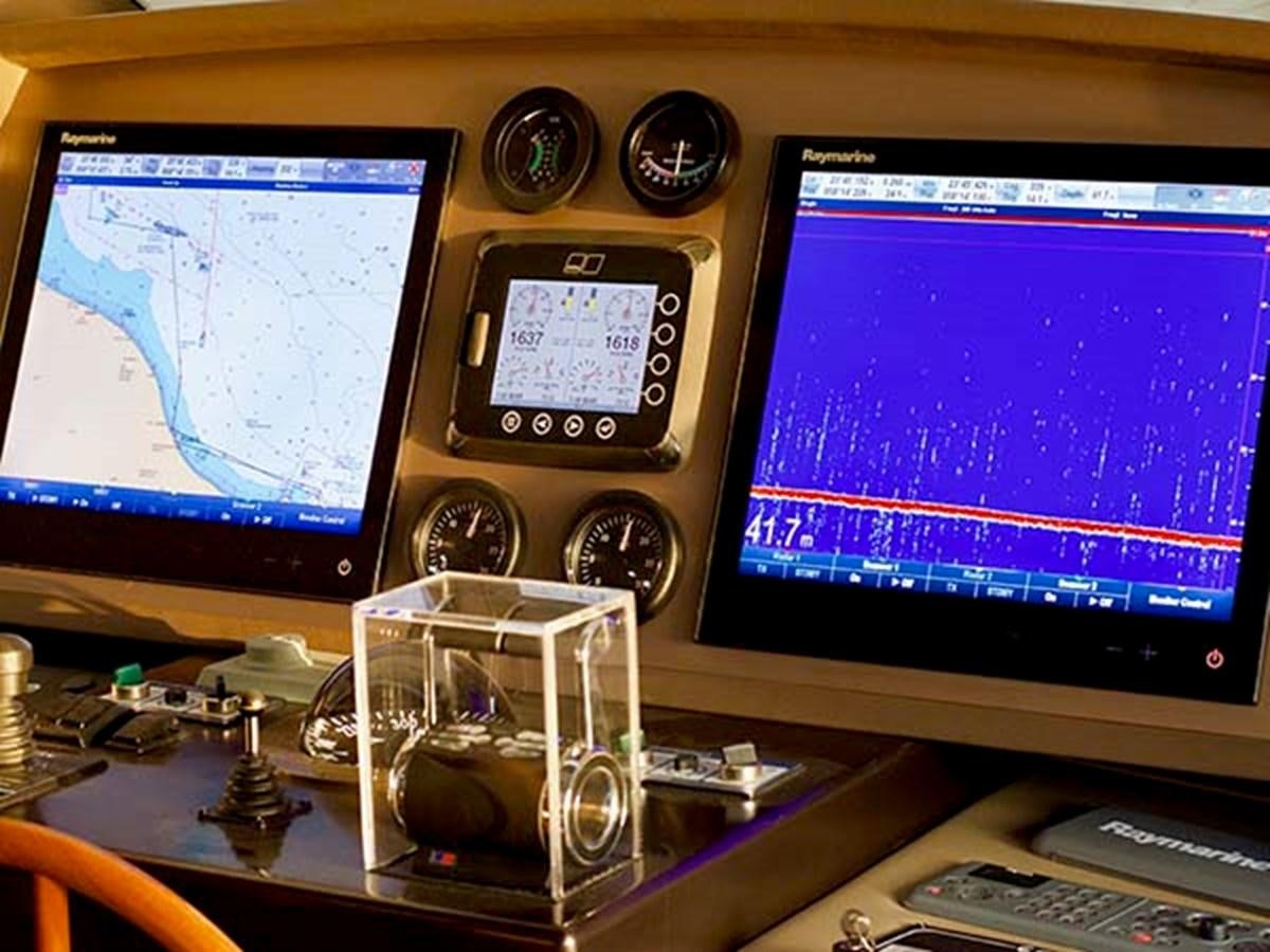 a desk with computers and monitors aboard AL WASMY I Yacht for Sale