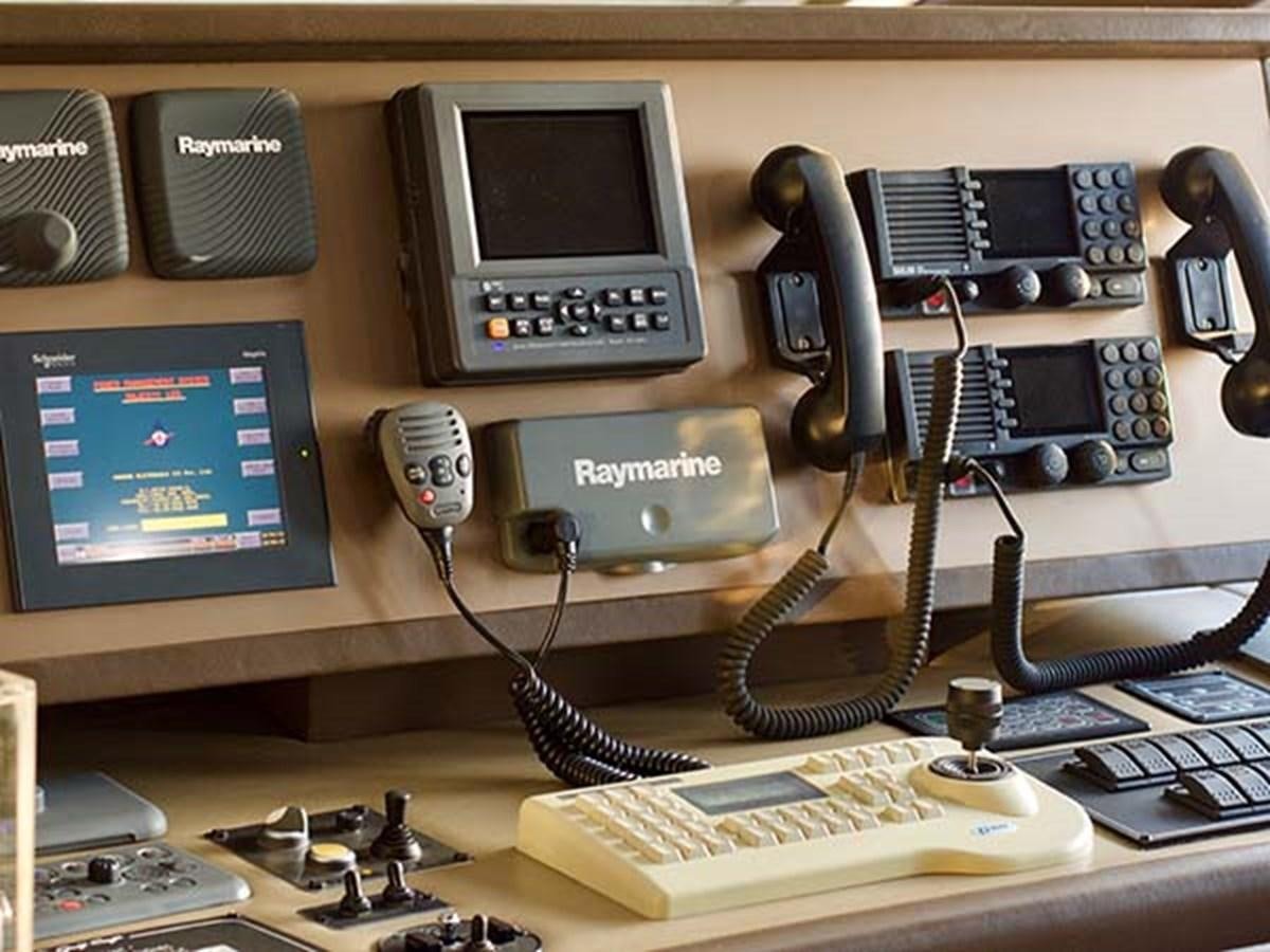 a desk with a laptop and other office items on it aboard AL WASMY I Yacht for Sale