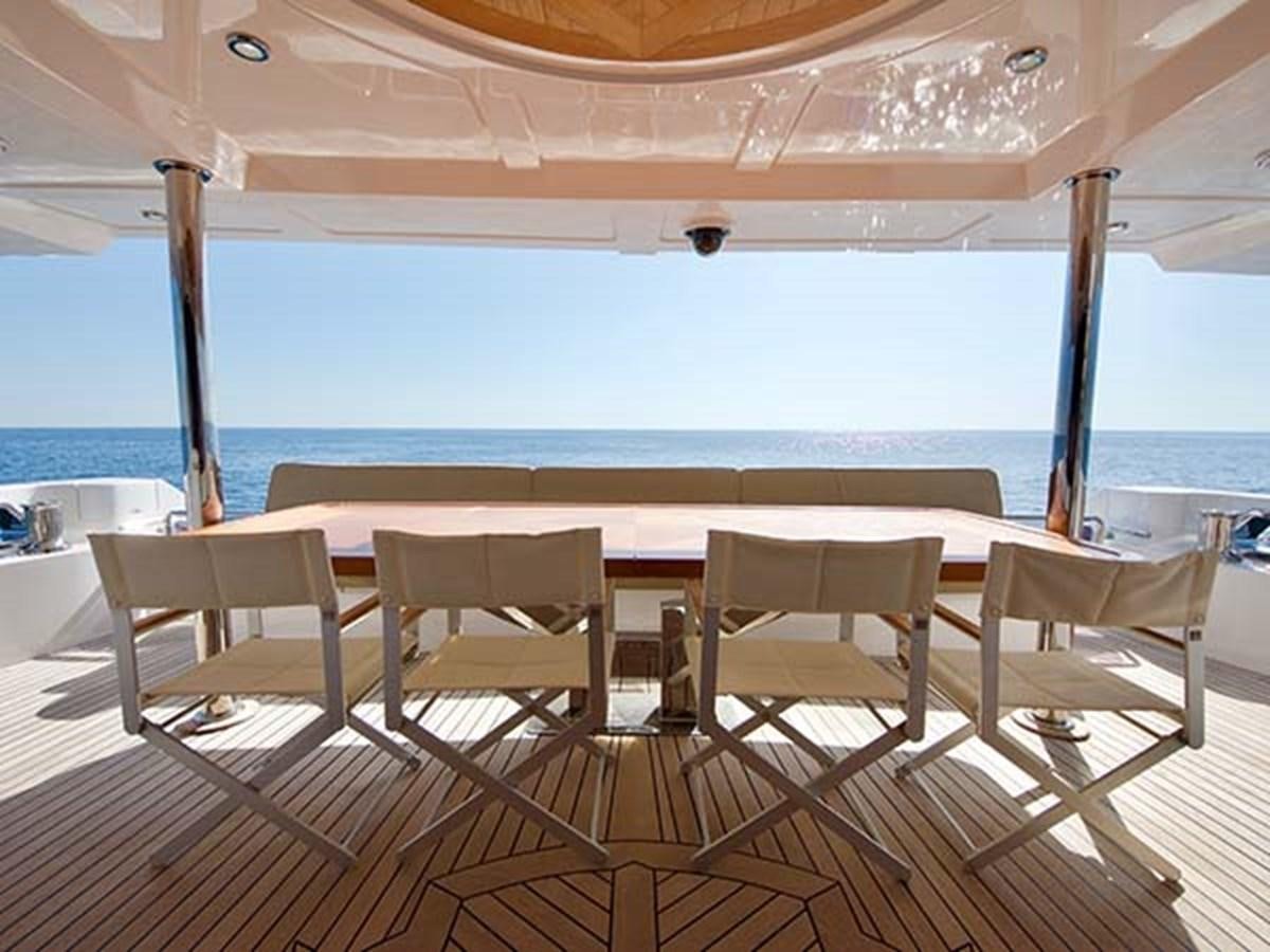 a table and chairs on a deck aboard AL WASMY I Yacht for Sale