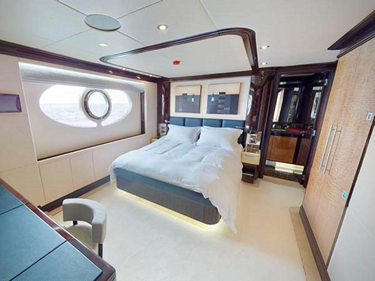 a room with a bed and a bookcase aboard AL WASMY I Yacht for Sale