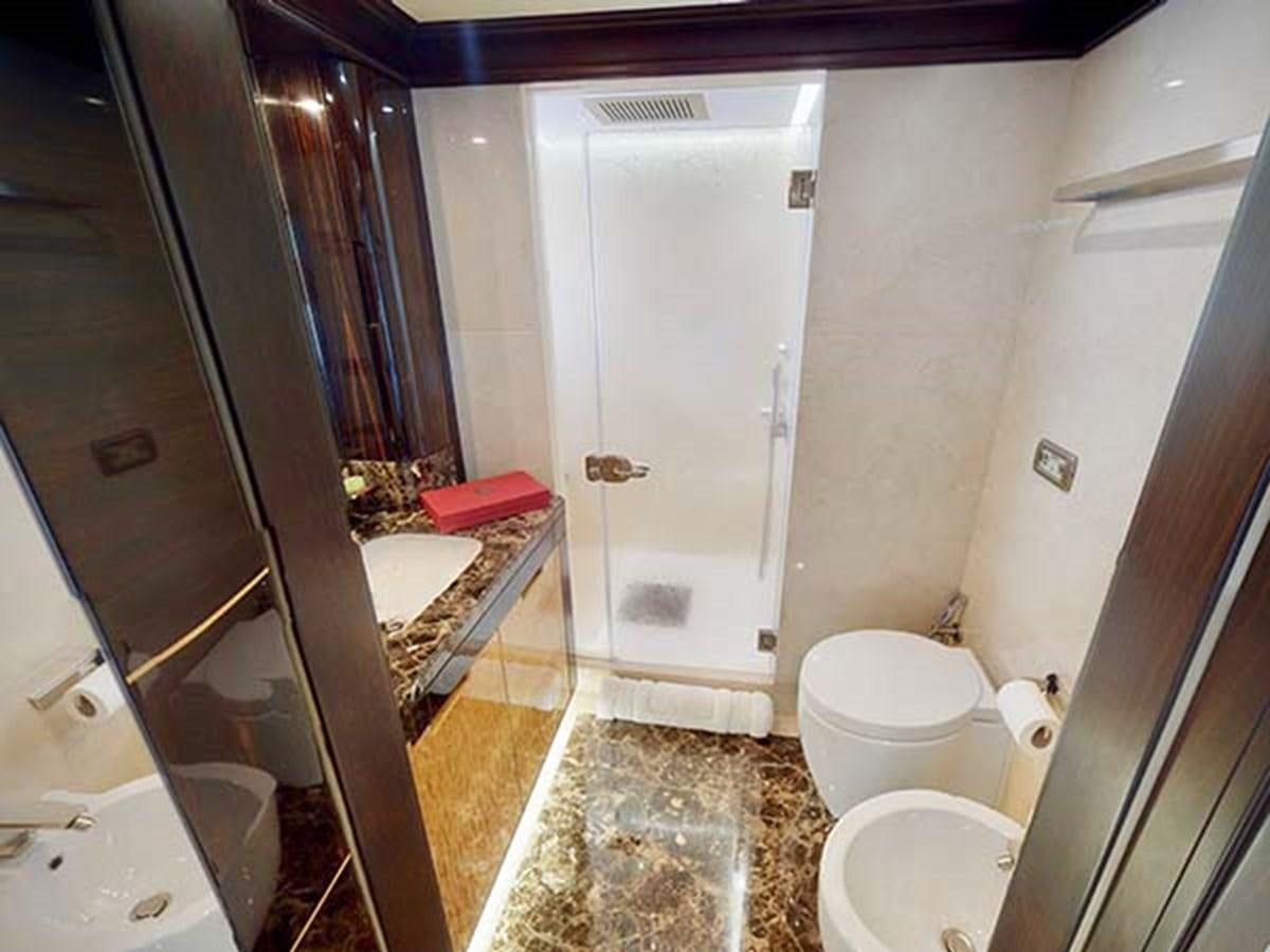 a bathroom with a tub and toilet aboard AL WASMY I Yacht for Sale