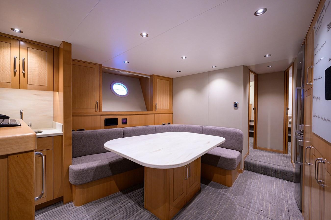 a large kitchen with a round table aboard MARSHA KAY Yacht for Sale