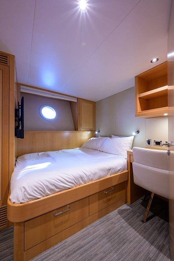 a bedroom with a bed and a desk aboard MARSHA KAY Yacht for Sale