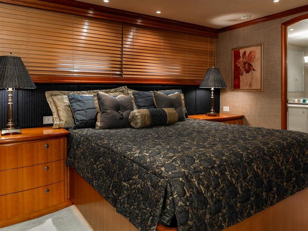 a bed with a black comforter aboard MURPHY'S LAW Yacht for Charter