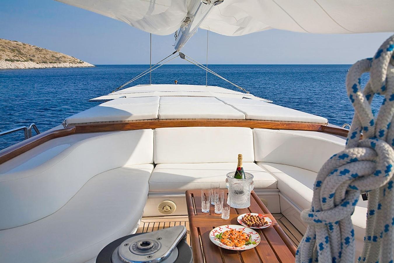 a boat with a table and food on it aboard ALTHEA Yacht for Sale