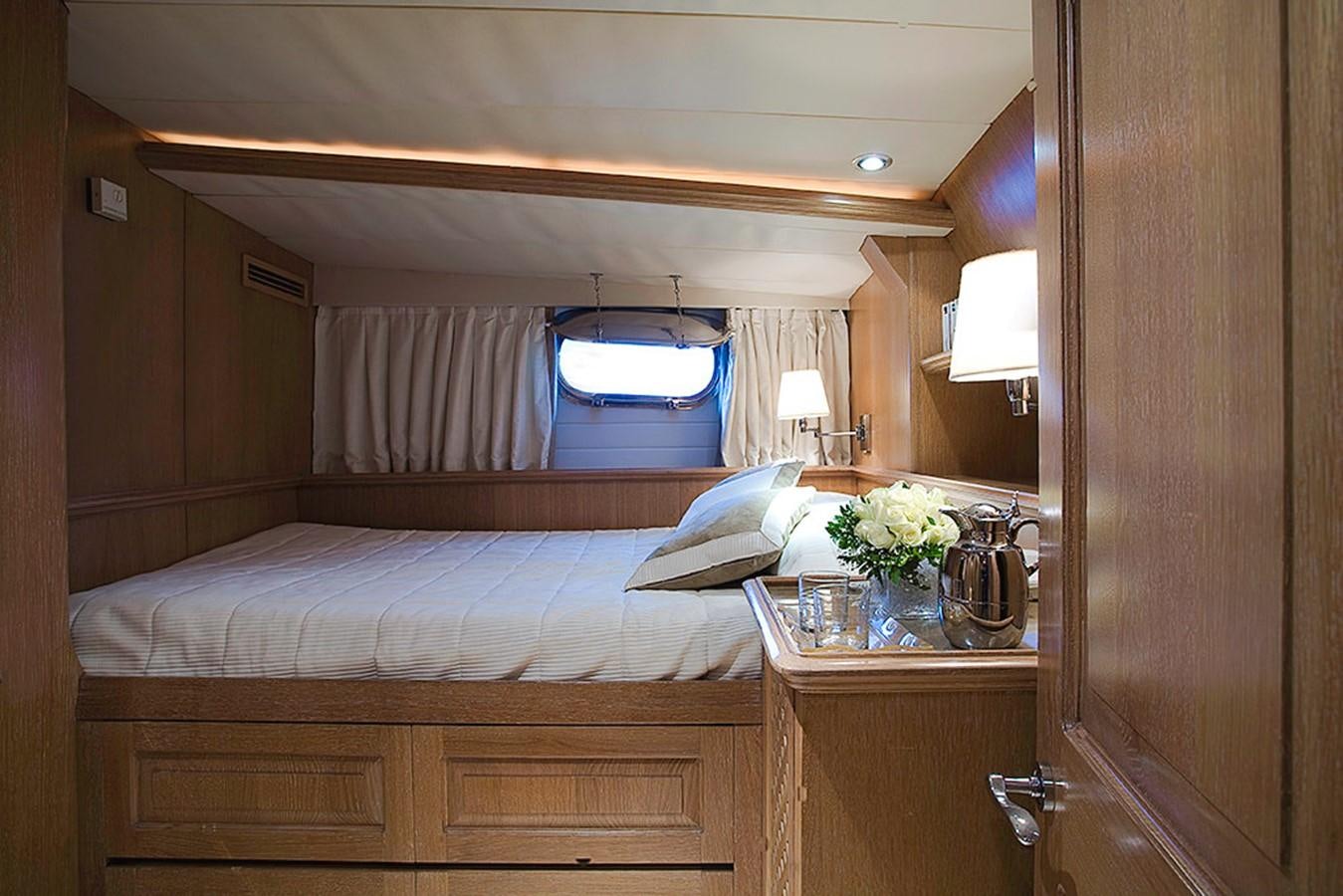 a bedroom with a large mirror aboard ALTHEA Yacht for Sale
