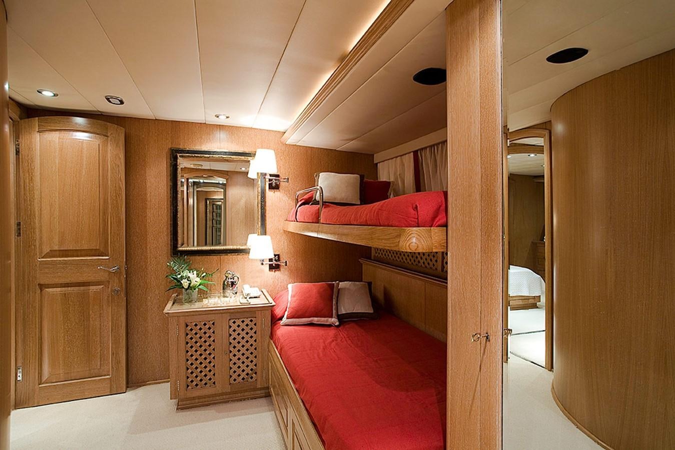 a bedroom with a bed and a mirror aboard ALTHEA Yacht for Sale